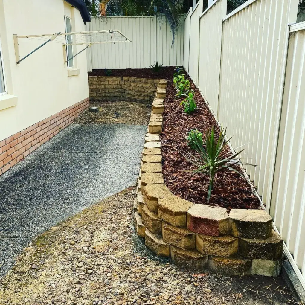Cleaned-up garden bed with fresh mulch and defined borders in Arundel